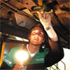 A mechanic works on a car